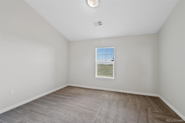 23451 E 5th Dr Unit 203, Aurora, CO 80018 - spare room featuring carpet, baseboards, and vaulted ceiling