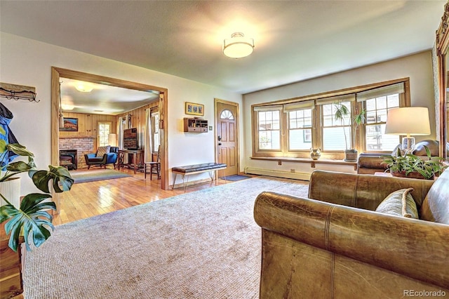587 21 1/8 Rd, Grand Junction, CO 81507 - living area with a fireplace, a baseboard heating unit, and wood finished floors