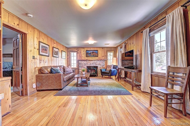 587 21 1/8 Rd, Grand Junction, CO 81507 - living room featuring light wood-style floors, wood walls, and a fireplace