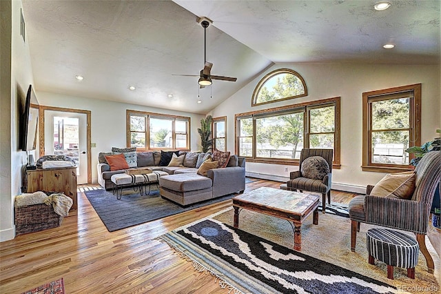 587 21 1/8 Rd, Grand Junction, CO 81507 - living area featuring ceiling fan, recessed lighting, wood finished floors, vaulted ceiling, and a baseboard heating unit