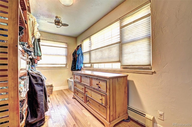 587 21 1/8 Rd, Grand Junction, CO 81507 - walk in closet featuring ceiling fan, a baseboard heating unit, and light wood-type flooring