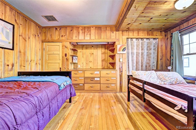 587 21 1/8 Rd, Grand Junction, CO 81507 - bedroom with wooden walls, visible vents, ornamental molding, and hardwood / wood-style floors