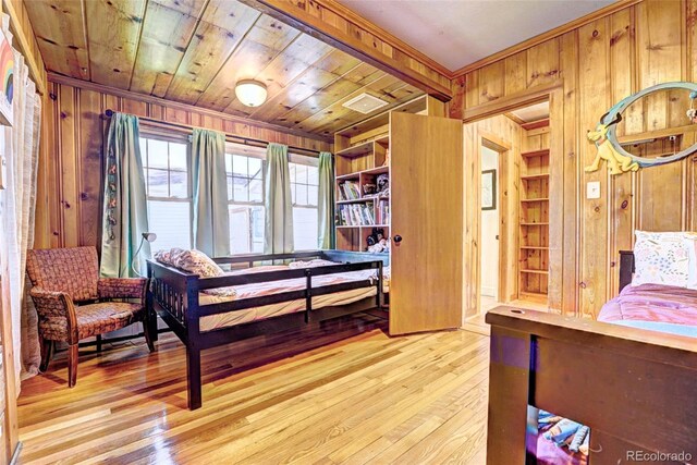587 21 1/8 Rd, Grand Junction, CO 81507 - bedroom featuring ornamental molding, light wood finished floors, and wooden walls