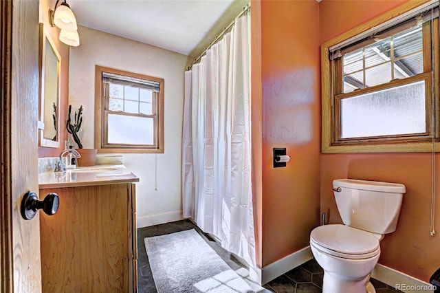 587 21 1/8 Rd, Grand Junction, CO 81507 - bathroom featuring tile patterned flooring, vanity, toilet, a shower with shower curtain, and baseboards