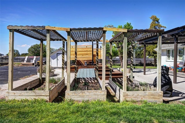 587 21 1/8 Rd, Grand Junction, CO 81507 - view of yard featuring a vegetable garden, a storage unit, a pergola, and an outbuilding