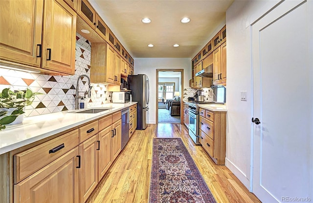 587 21 1/8 Rd, Grand Junction, CO 81507 - kitchen featuring appliances with stainless steel finishes, extractor fan, decorative backsplash, recessed lighting, and light wood-type flooring