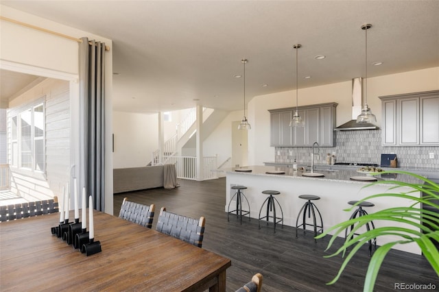 dining room with dark hardwood / wood-style flooring and sink