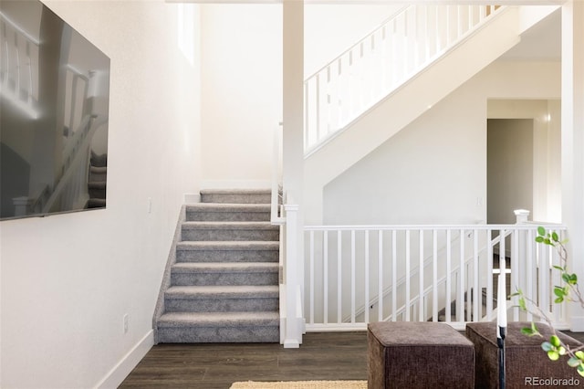 stairs featuring wood-type flooring