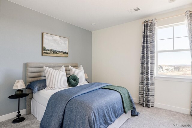 bedroom with light colored carpet