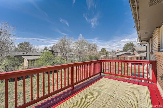 wooden deck with a yard and a fenced backyard