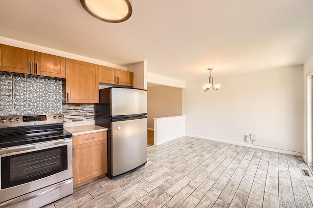 13086 E Alaska Ave, Aurora, CO 80012 - kitchen with appliances with stainless steel finishes, a chandelier, tasteful backsplash, light wood-style flooring, and light countertops
