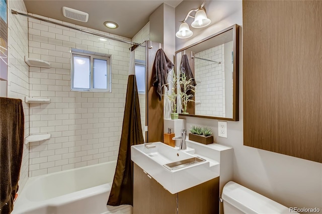 full bathroom with vanity, shower / tub combo with curtain, and toilet