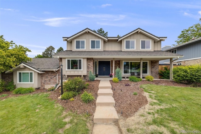 5991 S Eudora Way, Centennial, CO 80121 - traditional-style home featuring brick siding, a front lawn, a porch, and board and batten siding