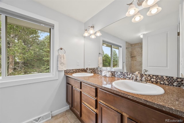 5991 S Eudora Way, Centennial, CO 80121 - bathroom with double vanity, tiled shower, baseboards, and tile patterned floors
