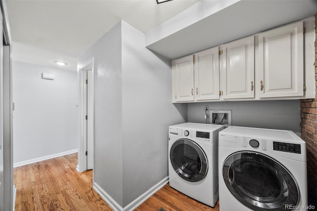 5991 S Eudora Way, Centennial, CO 80121 - laundry area with light wood-style floors, washing machine and dryer, baseboards, and cabinet space