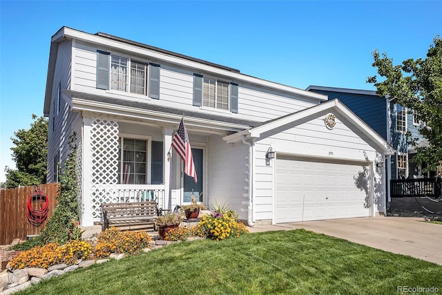 view of front of home featuring covered porch, a front yard, and a garage