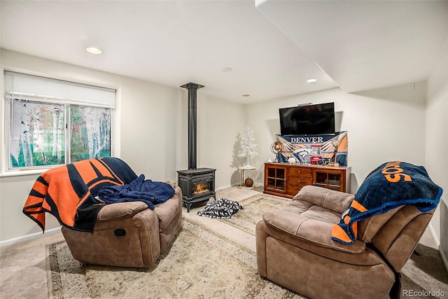 carpeted living room featuring a wood stove