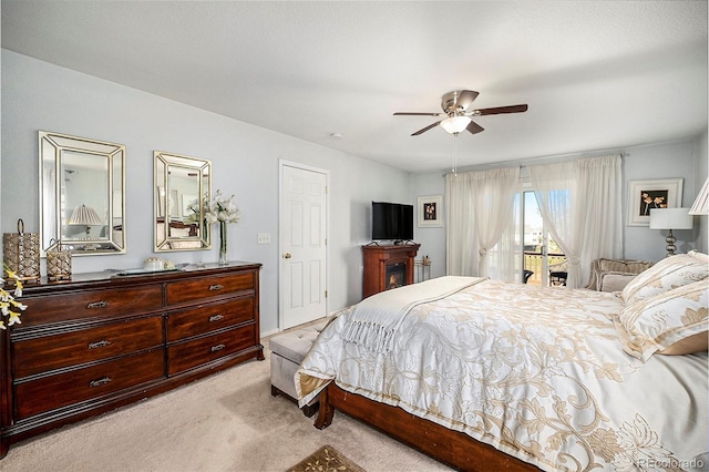 carpeted bedroom featuring access to exterior and ceiling fan