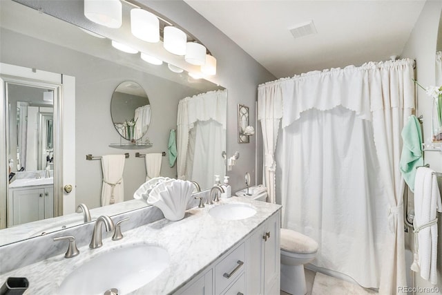 bathroom with vanity and toilet