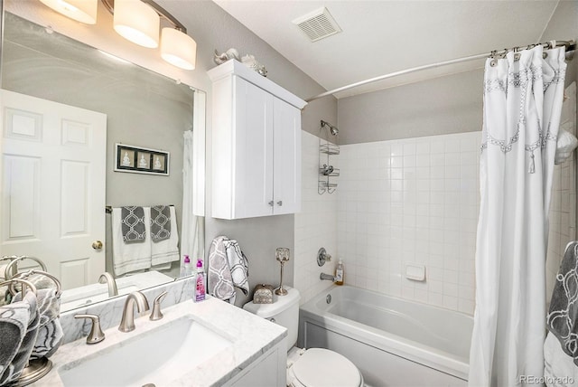 full bathroom with vanity, shower / tub combo with curtain, and toilet