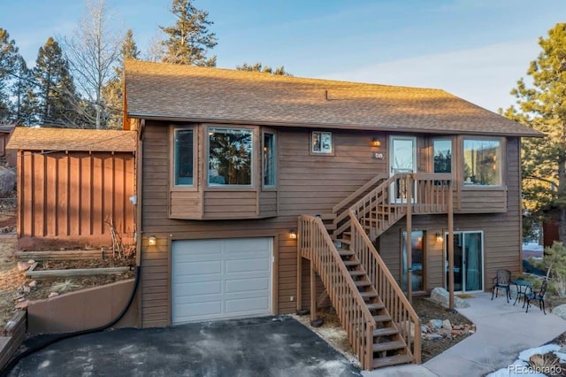 rear view of house with a garage