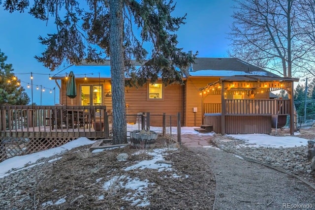 snow covered property featuring a wooden deck