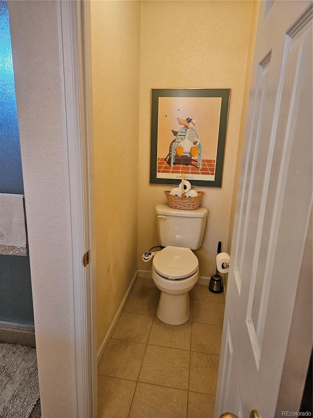 bathroom with toilet and tile patterned floors