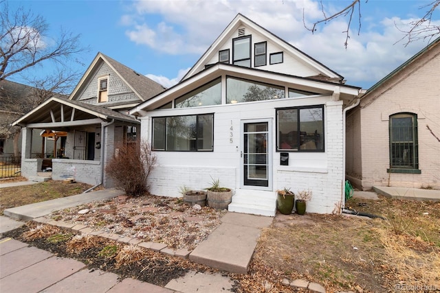 view of front of home with entry steps and brick siding