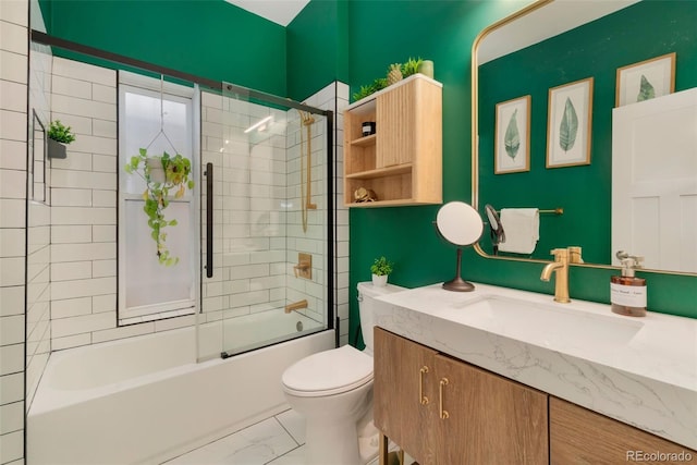 bathroom with marble finish floor, shower / bath combination with glass door, vanity, and toilet