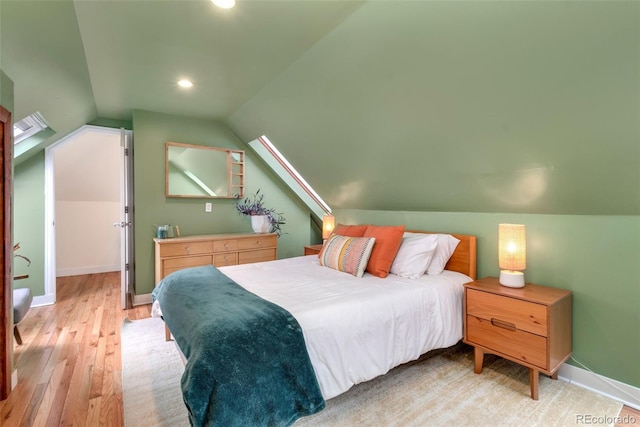 bedroom featuring recessed lighting, vaulted ceiling, light wood finished floors, and baseboards