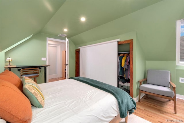 bedroom featuring baseboards, wood finished floors, vaulted ceiling, a closet, and recessed lighting