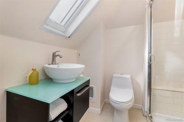 full bathroom with toilet, lofted ceiling with skylight, a stall shower, vanity, and tile patterned flooring