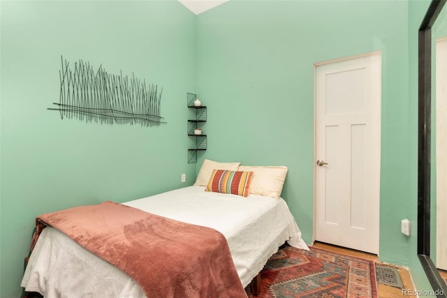 bedroom with visible vents and wood finished floors