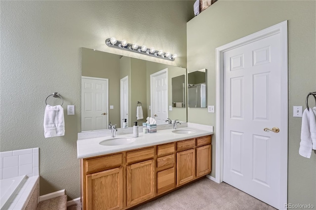 bathroom with tiled bath and vanity