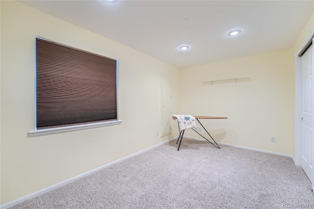 miscellaneous room with light colored carpet