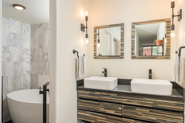 bathroom with tile walls, a bathtub, and vanity