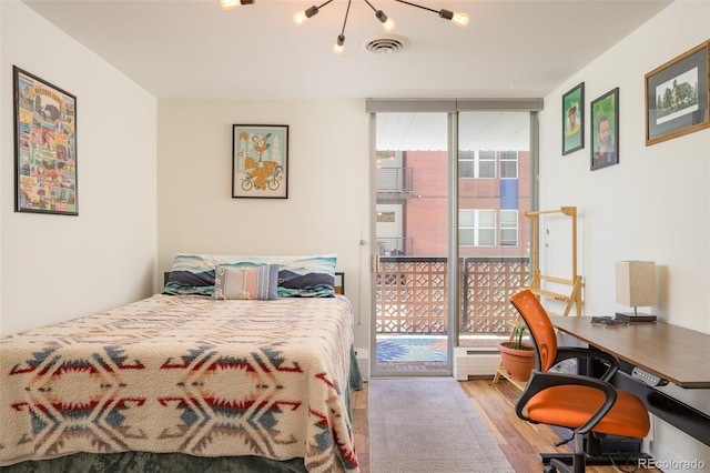 bedroom featuring access to exterior, floor to ceiling windows, and light hardwood / wood-style flooring