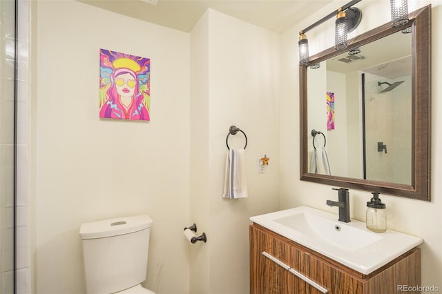 bathroom featuring toilet and vanity