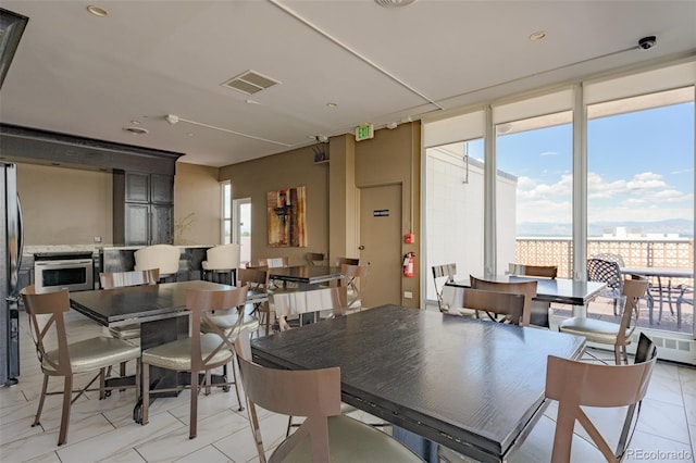 tiled dining space with a wealth of natural light and expansive windows