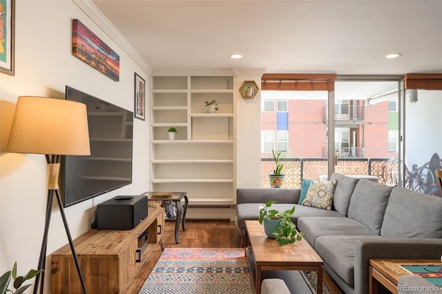 living room with crown molding and hardwood / wood-style flooring