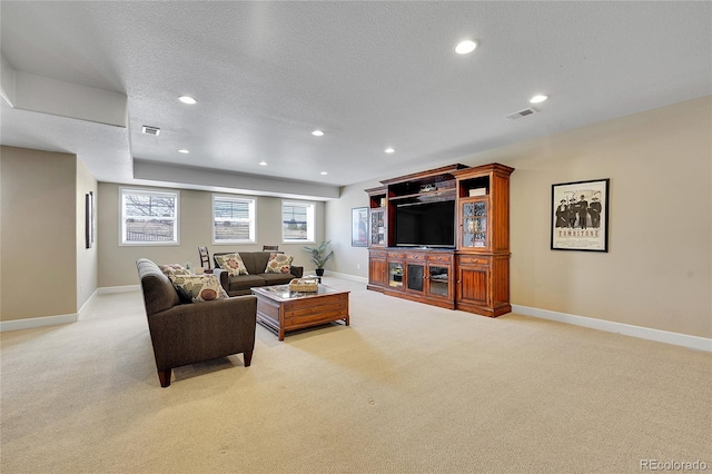living area with light carpet, baseboards, recessed lighting, and a textured ceiling