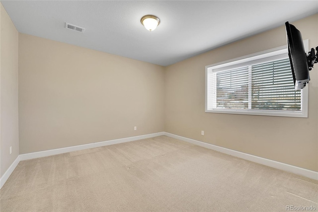 empty room featuring carpet flooring and baseboards