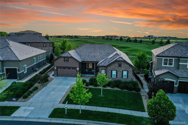 27615 E Moraine Dr, Aurora, CO 80016 - view of front of house with stone siding, driveway, a front lawn, and an attached garage