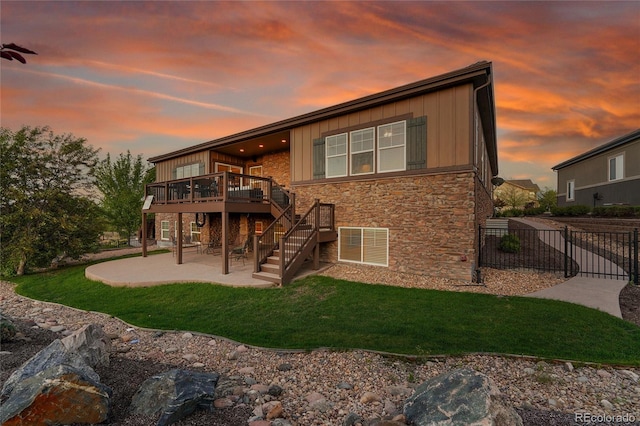 27615 E Moraine Dr, Aurora, CO 80016 - back of house featuring a patio, stone siding, a deck, board and batten siding, and stairs