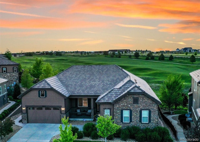 27615 E Moraine Dr, Aurora, CO 80016 - view of front of house with stone siding, concrete driveway, covered porch, and a garage