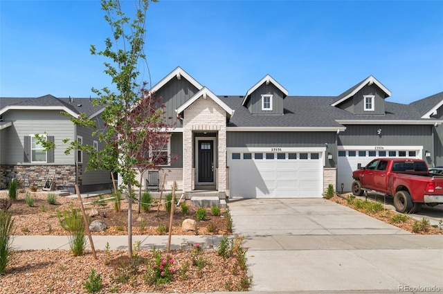 23936 E River Front Dr, Aurora, CO 80019 - craftsman inspired home with a garage, stone siding, and concrete driveway