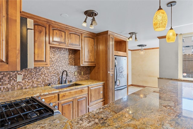 1196 N Grant St Unit 106, Denver, CO 80203 - kitchen featuring freestanding refrigerator, light stone counters, decorative backsplash, brown cabinetry, and ornamental molding
