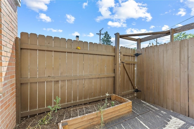 1196 N Grant St Unit 106, Denver, CO 80203 - view of patio / terrace with a gate and a vegetable garden