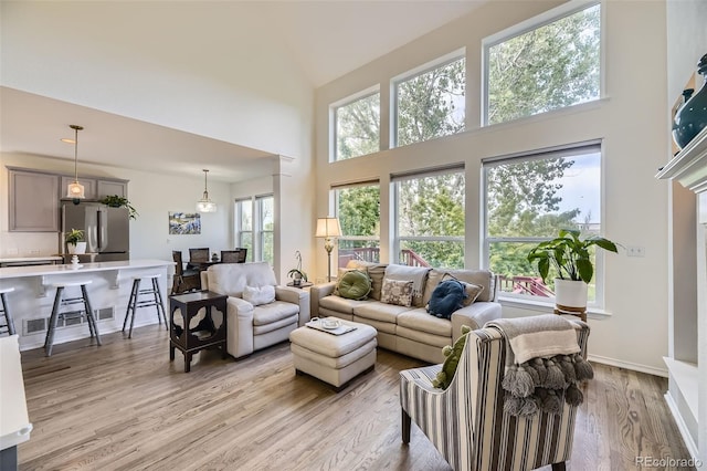 15649 E 7th Cir, Aurora, CO 80011 - living area with a high ceiling and light wood-style floors