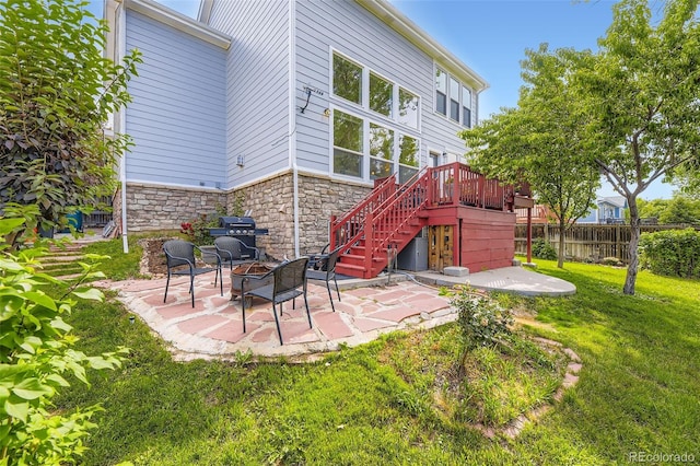 15649 E 7th Cir, Aurora, CO 80011 - rear view of property with a patio, stone siding, an outdoor fire pit, stairway, and a wooden deck